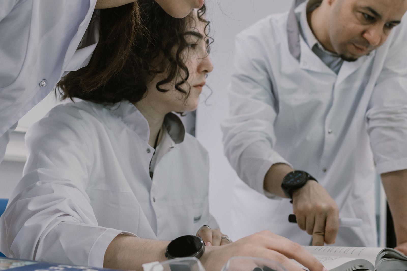 Group of scientists working together in a university laboratory, focused and collaborative atmosphere.